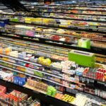 Aerial view of supermarket aisles filled with colorful products and packaging.