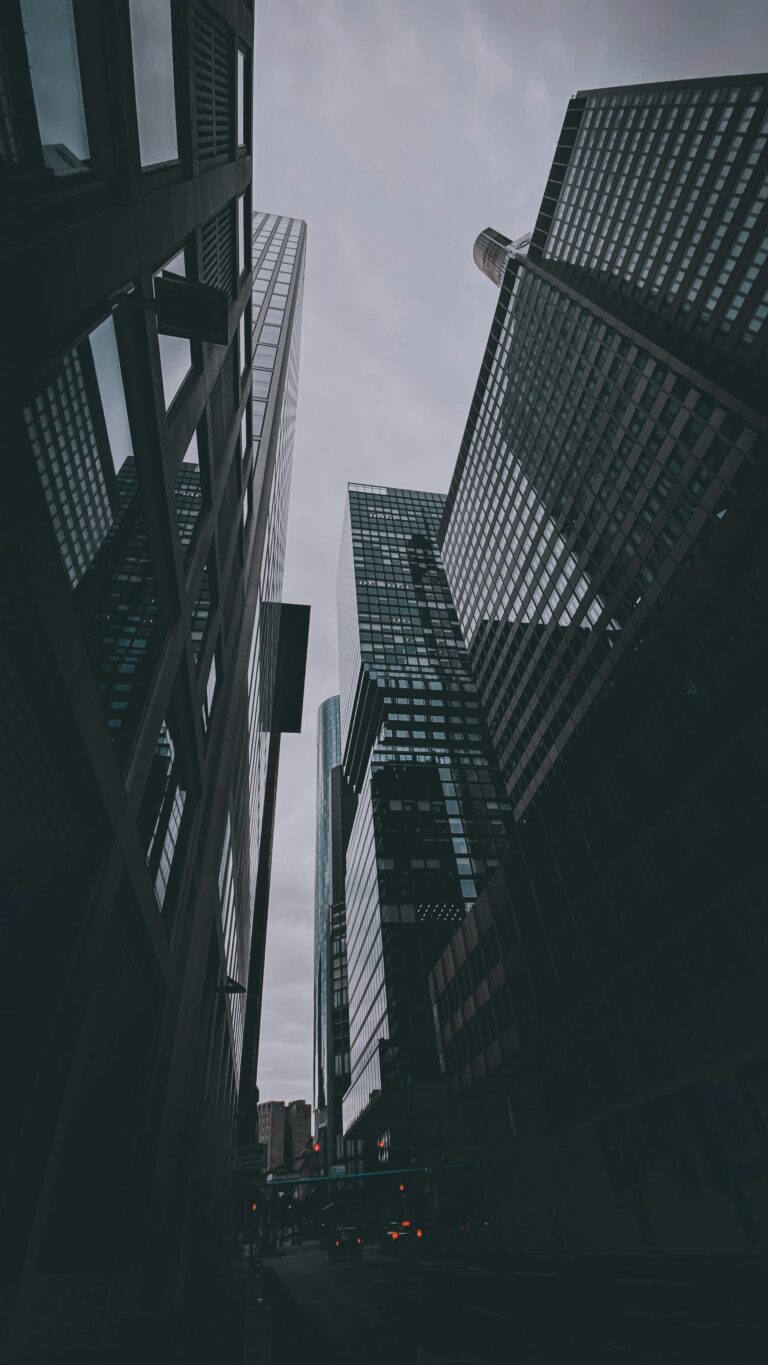 Dynamic cityscape featuring modern skyscrapers with a low-angle perspective, showcasing urban architecture.